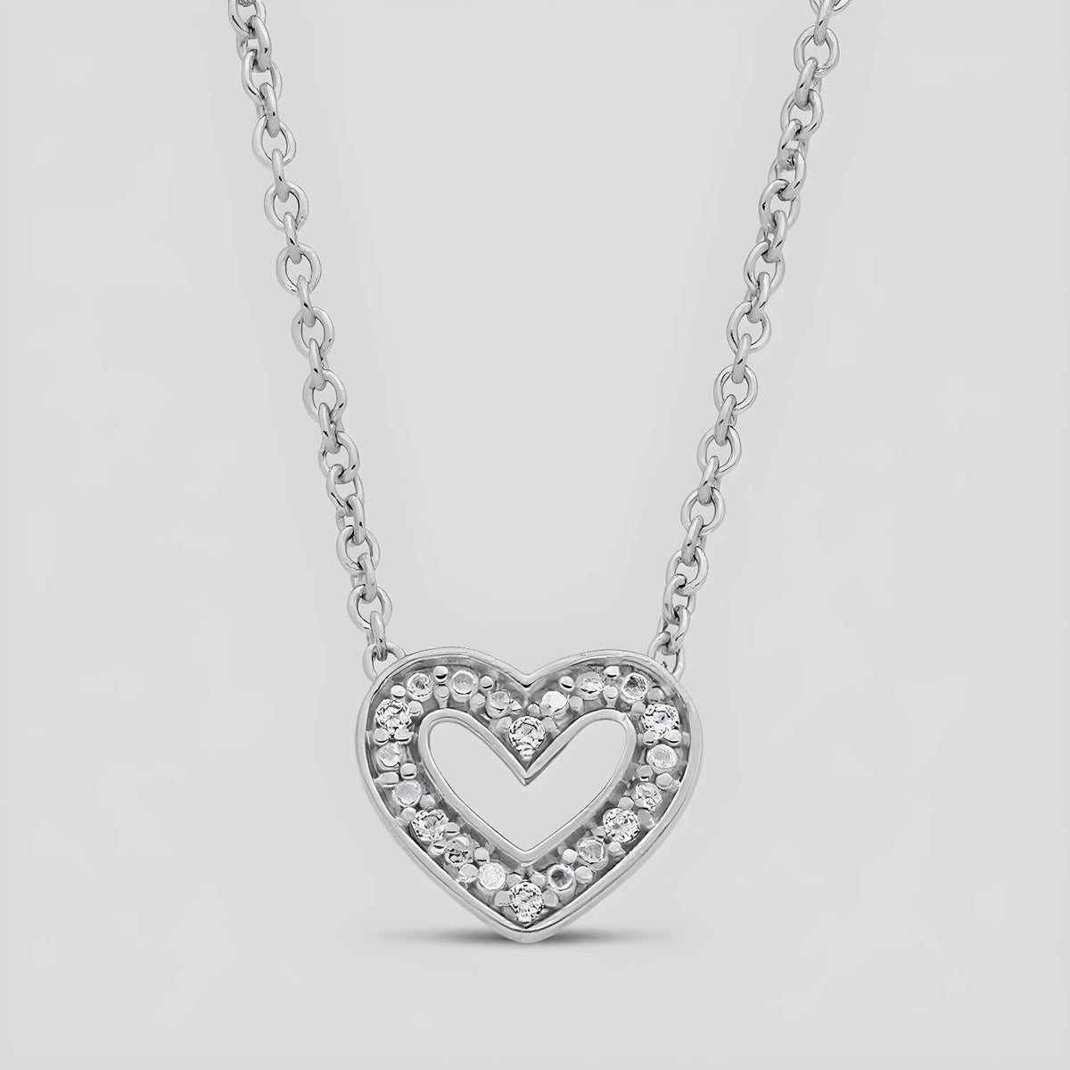 A double heart necklace with natural diamonds set in sterling silver, displayed against a plain background.