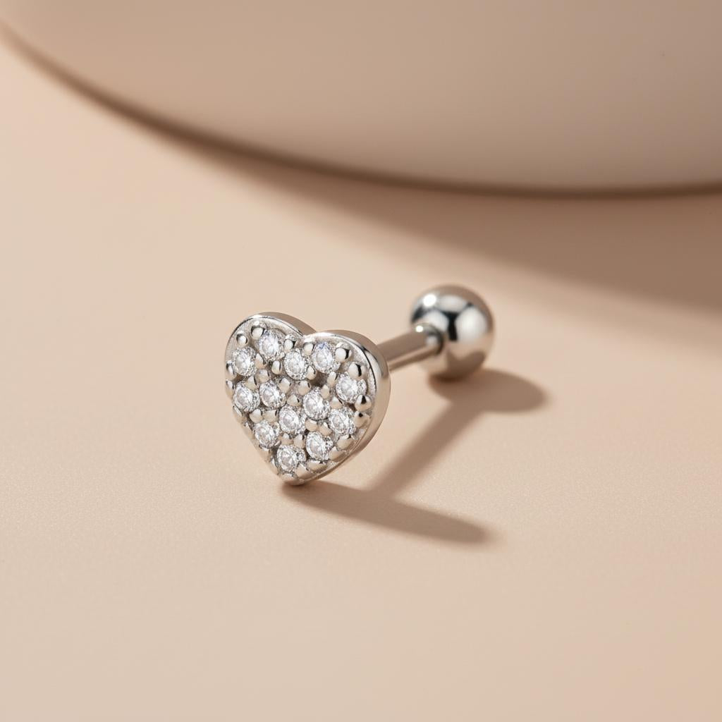 Sterling silver heart helix stud with cubic zirconia and a 6mm bar, shown on a beige surface.
