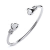 A polished, handcrafted Silversmiths sterling silver baby torque bangle with boxing gloves on a plain white background.