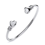 A polished, handcrafted Silversmiths sterling silver baby torque bangle with boxing gloves on a plain white background.