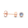 Front and side views of Silversmiths rose gold plated silver studs with simulated aquamarine stones.
