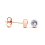 Front and side views of Silversmiths rose gold plated silver studs with simulated aquamarine stones.