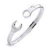 A silver men’s 7.2mm torque bangle features spanner and wrench terminals, displayed on a white background.