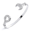 Sterling silver torque bangle with wrench-shaped open ends, each set with sparkling cubic zirconia stones.