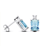 Sterling silver stud earrings featuring emerald-cut simulated blue topaz and secure push-back closures.