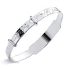 Silversmiths’ sterling silver expanding baby bangle with a floral-patterned ID plate.