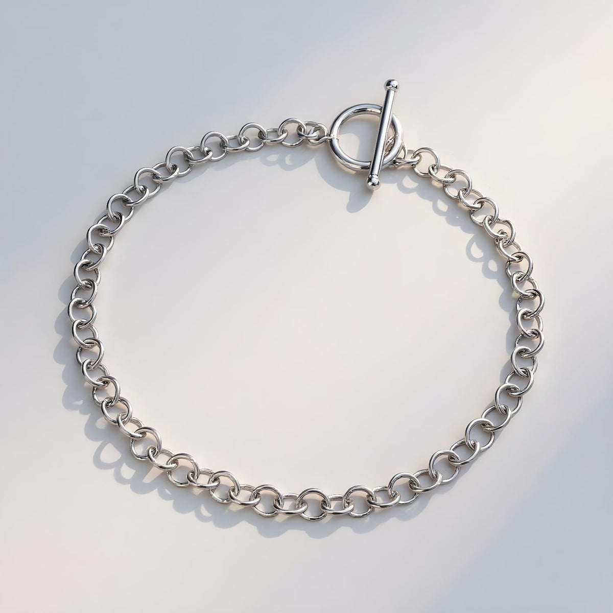 A Silversmiths sterling silver 4mm T-bar Belcher bracelet rests on a light, neutral background.