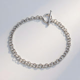 A Silversmiths sterling silver 4mm T-bar Belcher bracelet rests on a light, neutral background.