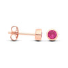 Rose gold plated silver stud earrings with simulated ruby in bezel setting, shown front and side on white background.