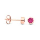 Rose gold plated silver stud earrings with simulated ruby in bezel setting, shown front and side on white background.