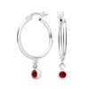 Sterling silver hoop earrings with simulated garnet gemstone charms hanging from each hoop.