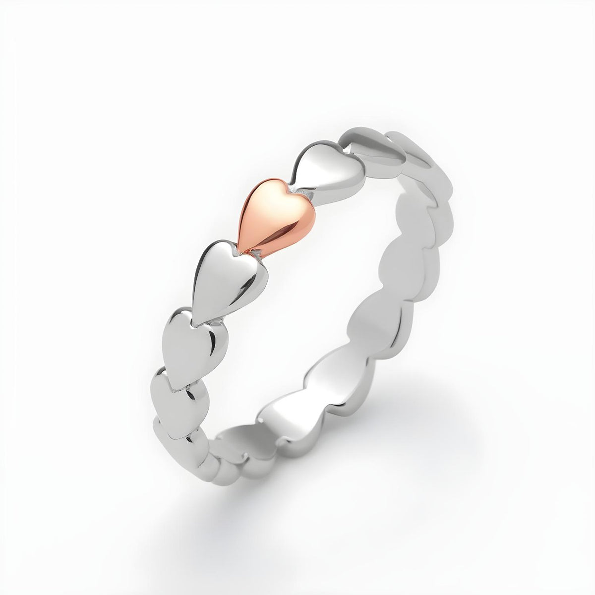 Sterling silver band ring featuring linked hearts and a central rose gold-plated heart.