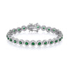 A sterling silver tennis bracelet with simulated emeralds and CZ halos, shown with a secure clasp on a white background.