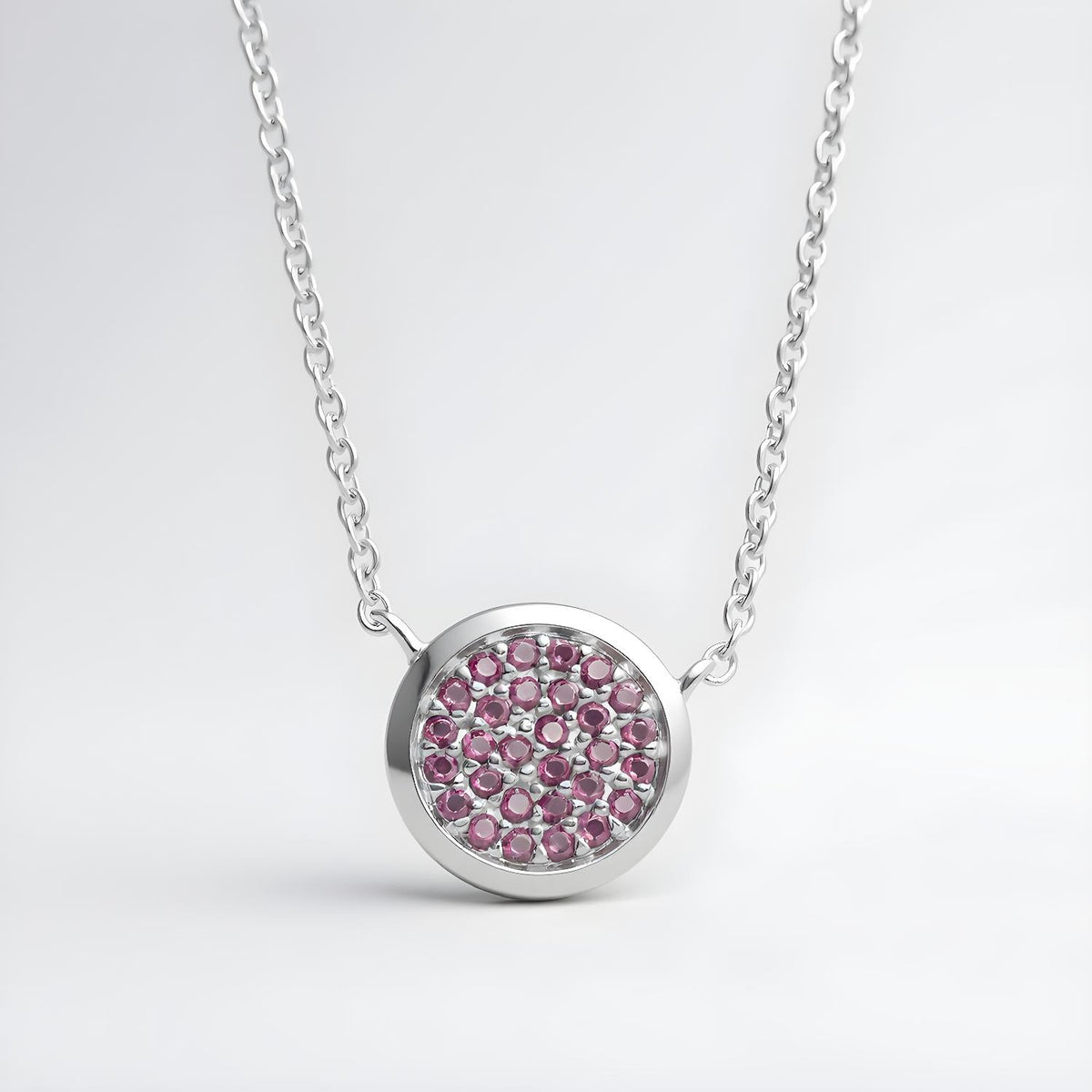 Sterling silver necklace with a circle cluster pendant set with simulated rubies in a polished design.