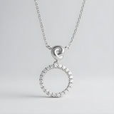 Sterling silver necklace featuring an infinity love knot circle design with cubic zirconia accents.