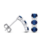 Silversmiths sterling silver drop stud earrings with simulated sapphire and CZ, shown from front and side views.