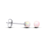 Silversmiths sterling silver round stud earrings feature simulated opals set in simple, polished mounts.