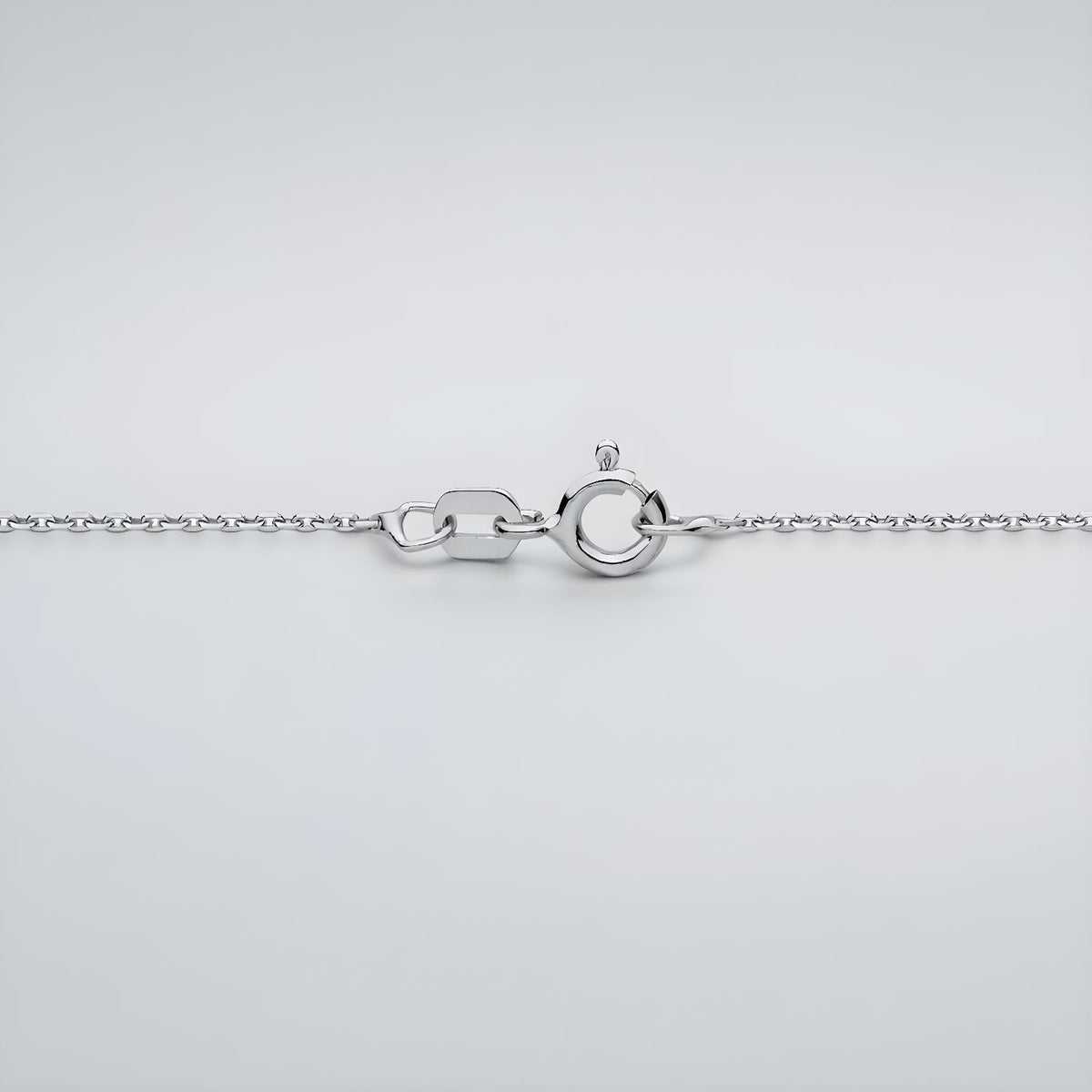 Silversmiths Sterling Silver 1mm diamond cut rolo chain necklace with spring ring clasp shown on a gray background.