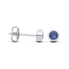 Silversmiths sterling silver stud earrings with faceted simulated sapphire bezel, shown front and side on white background.