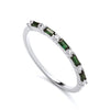 Sterling silver ring featuring alternating simulated emerald and cubic zirconia baguettes around the band.