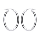 Sterling silver oval hoop earrings by Silversmiths, 34.5mm with hinged clasps, displayed on a white background.