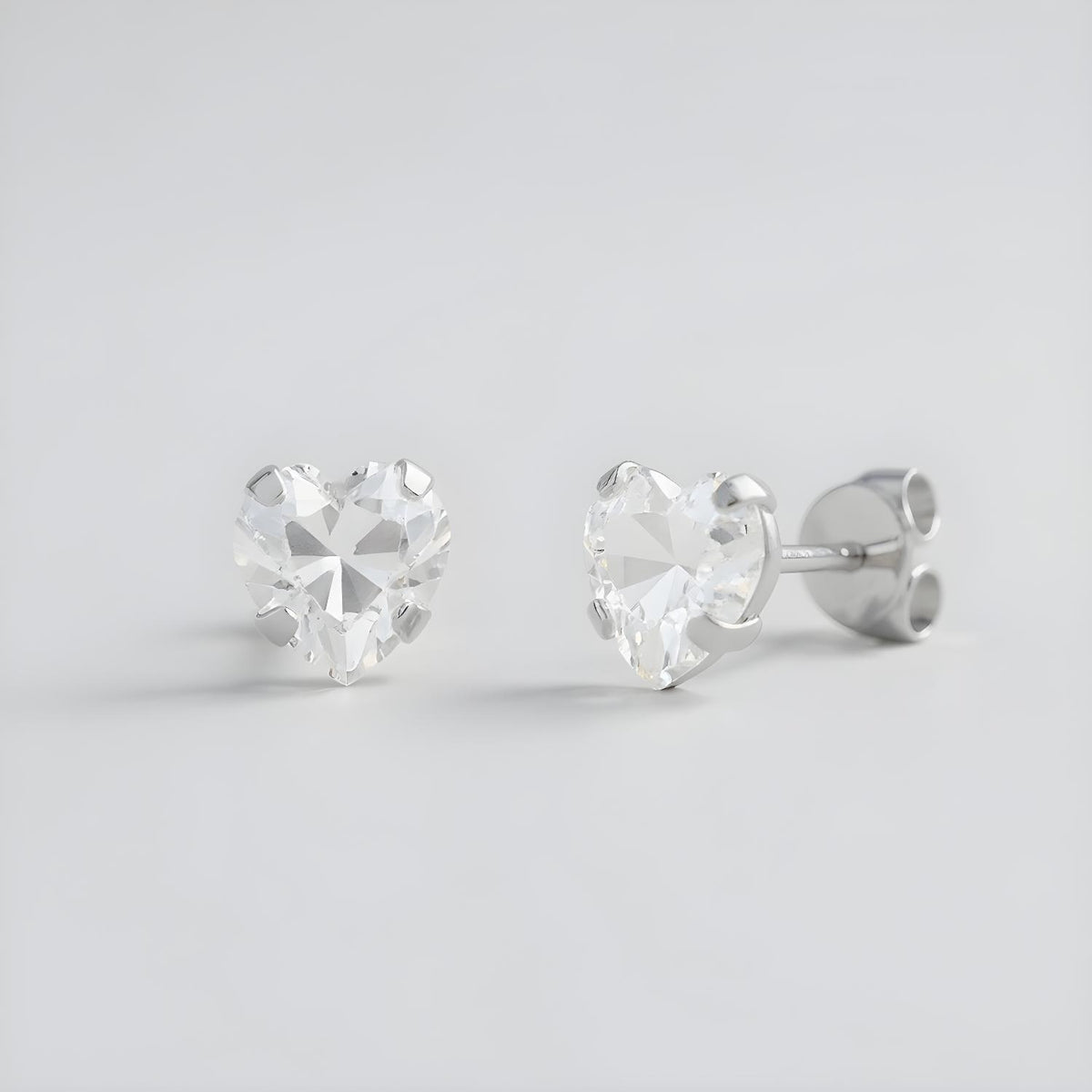 Silversmiths sterling silver 6mm heart-cut cubic zirconia studs displayed from front and side on a plain background.