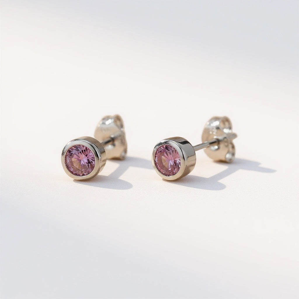 Silversmiths sterling silver stud earrings feature round simulated amethyst stones against a white background.
