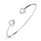 Sterling silver bangle by Silversmiths featuring cubic zirconia heart motifs in a simple, polished design.