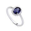 Sterling silver ring by Silversmiths featuring a simulated sapphire center and cubic zirconia accents on a thin band.
