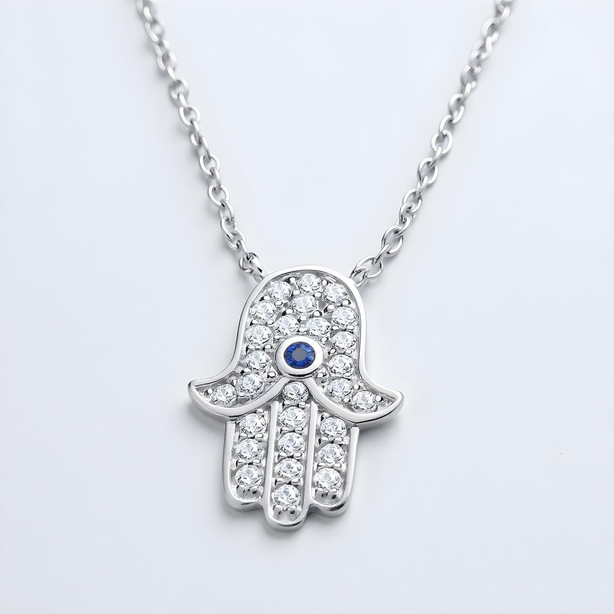 Sterling silver Hamsa necklace with simulated sapphire and cubic zirconia on a fine chain.