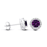 Sterling silver stud earrings with round simulated amethyst centers and clear cubic zirconia halo accents.