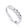 Sterling silver eternity ring with five bezel-set cubic zirconia stones on a wavy, polished band.