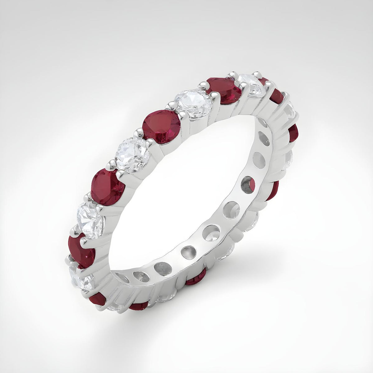 Sterling silver eternity ring by Silversmiths with simulated rubies and cubic zirconia in a continuous band design.