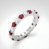 Sterling silver eternity ring by Silversmiths with simulated rubies and cubic zirconia in a continuous band design.