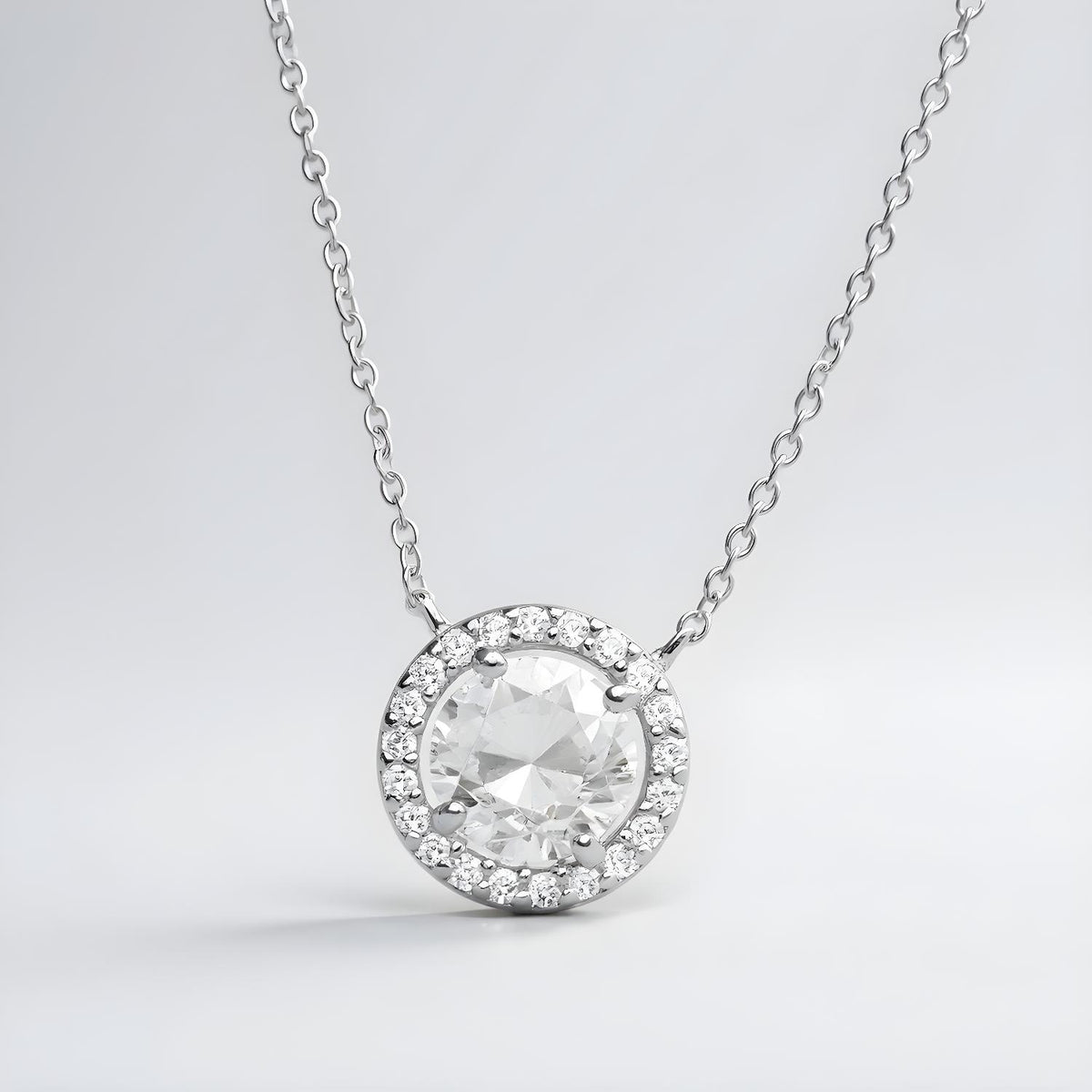 Silversmiths sterling silver necklace with a cubic zirconia center stone and a halo of small sparkling accents.