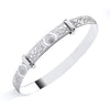 A Sterling Silver baby bangle by Silversmiths features an engraved Celtic knot motif, shown on a white background.