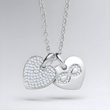 A sterling silver necklace with a CZ double heart and infinity charm, displayed against a plain background.