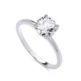 A sterling silver ring with a round cubic zirconia solitaire and a plain band, shown on a white background.