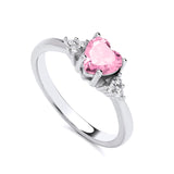 Sterling silver ring featuring a heart-shaped simulated pink sapphire and clear sparkling side accents.
