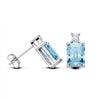 Sterling silver stud earrings featuring emerald-cut simulated blue topaz and secure push-back closures.