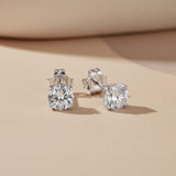 Silversmiths Sterling Silver 5mm cubic zirconia stud earrings rest on a light beige surface.