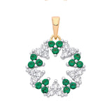 Two tone sterling silver circle pendant featuring simulated emerald and cubic zirconia in a floral wreath design.
