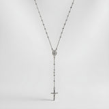 A Silversmiths Sterling Silver 24″ rosary bead necklace with a medallion and cross on a white background.