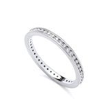 A sterling silver eternity ring by Silversmiths with round cut channel set cubic zirconia on a white background.