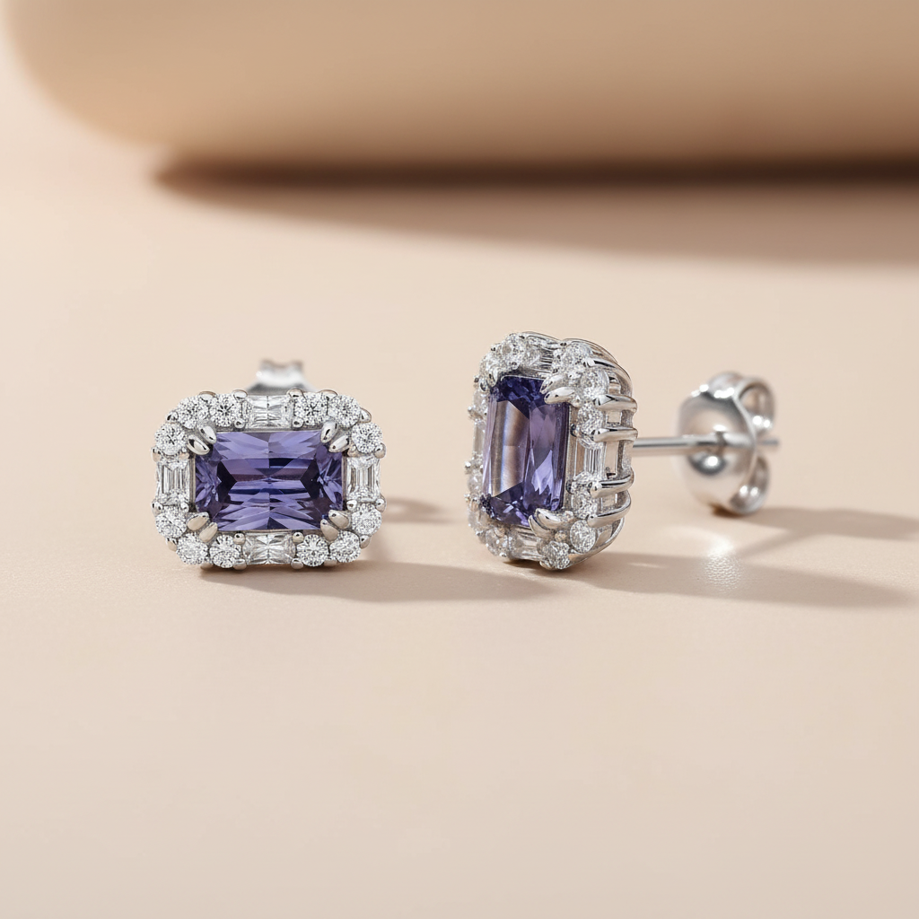 Sterling silver stud earrings with emerald-cut simulated tanzanite and a halo design rest on a beige surface.