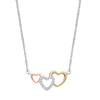 A sterling silver necklace with three cubic zirconia hearts in rose and yellow gold on a fine silver chain.