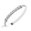 Sterling silver ladies’ bangle with engraved Celtic patterns and circular motifs displayed on a white background.