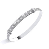 Sterling silver ladies’ bangle with engraved Celtic patterns and circular motifs displayed on a white background.