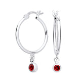 Sterling silver hoop earrings with simulated garnet gemstone charms hanging from each hoop.
