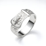 Sterling silver ring with engraved details and a distinct patterned buckle design.